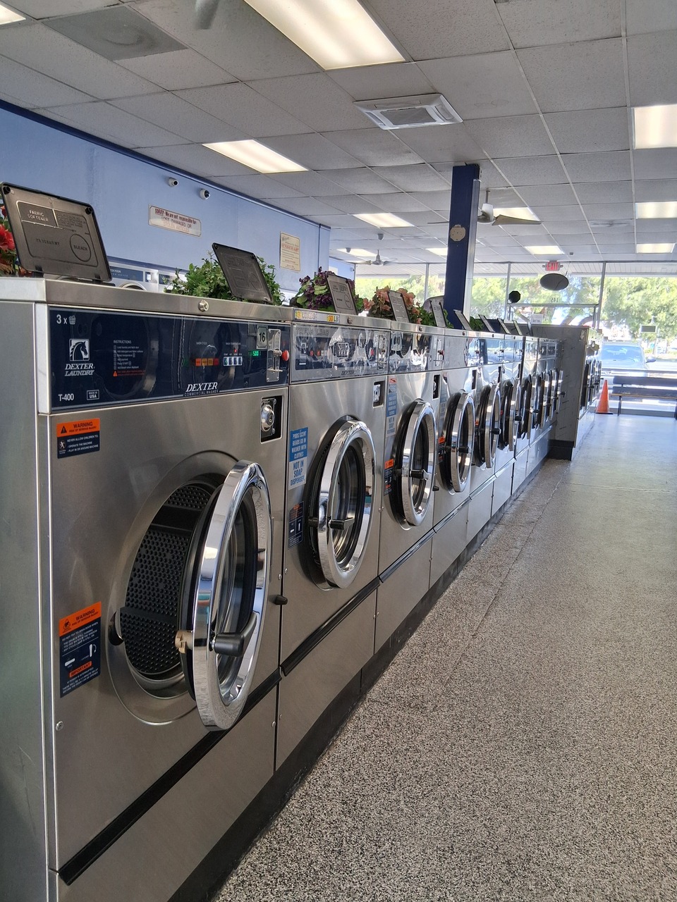 Row of Dexter T-400 washers along the wall at a clean, well-maintained laundromat in Hemet, CA