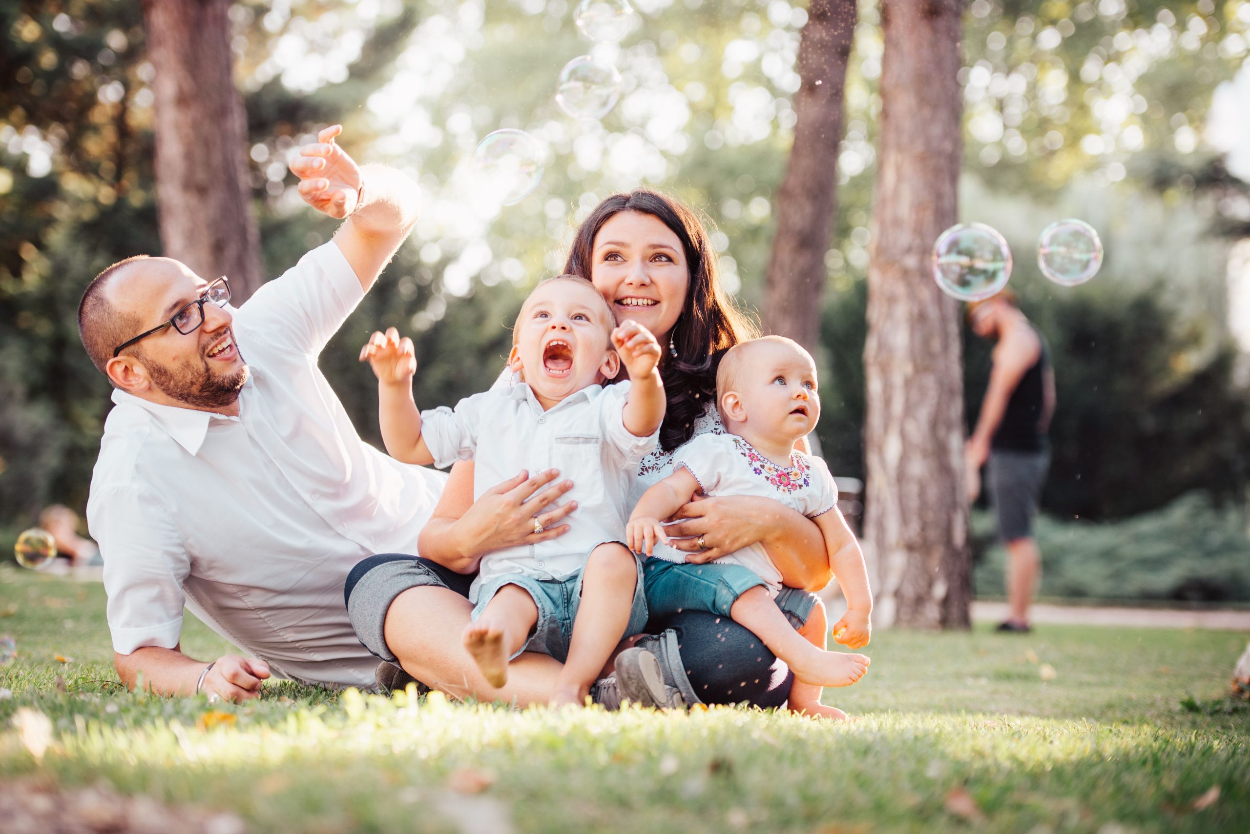 family-playing-with-bubbles-in-the-park family-playing-with-bubbles-in-the-park